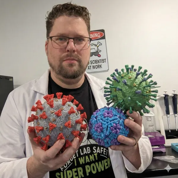 Rick Byers holding a giant Coronavirus, Rhinovirus and Influenza virus. Generated by Gemini Nano Banana AI.